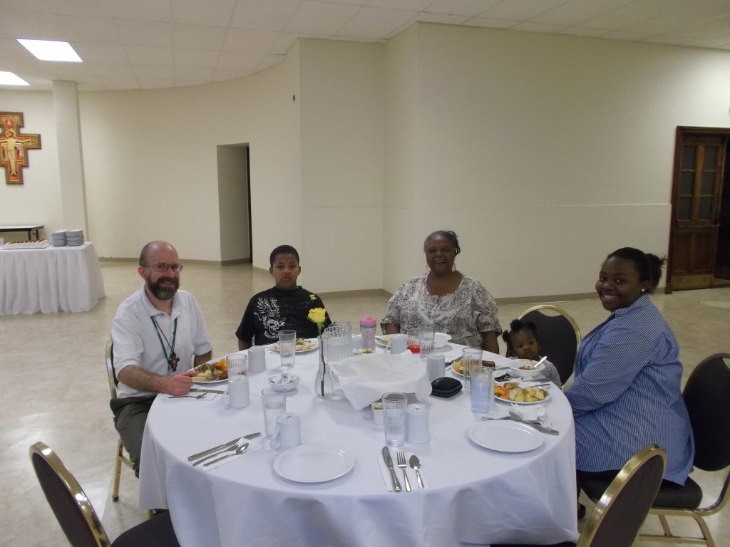 Our new postulant, Matt, visits with neighbors over dinner.