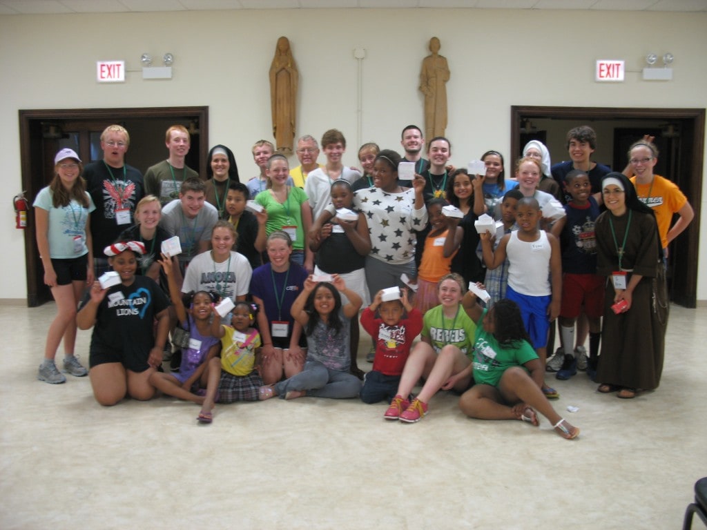 Kids, volunteers and sisters with the houses they built. They learned about the 4th Commandment, and inside their houses they put names of their parents and all the people in their lives they should honor and respect.