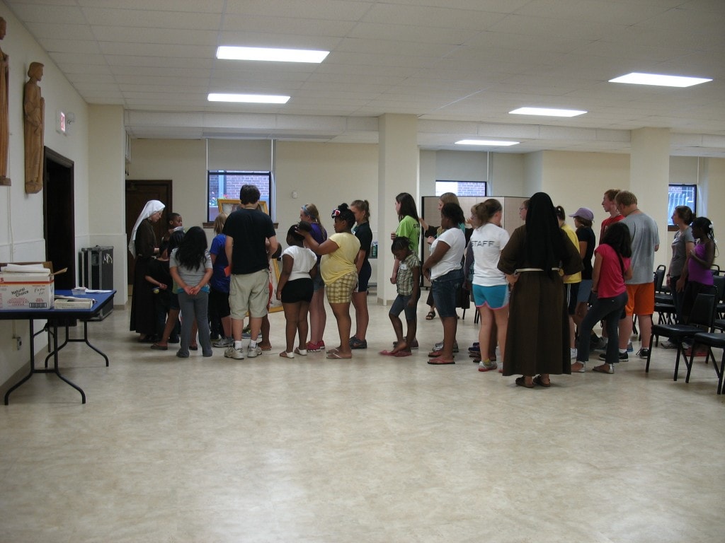 Kids and volunteers line up for the procession with the picture of Our Lady of Guadalupe into the Church. We sang "I love You Lord" as we processed.