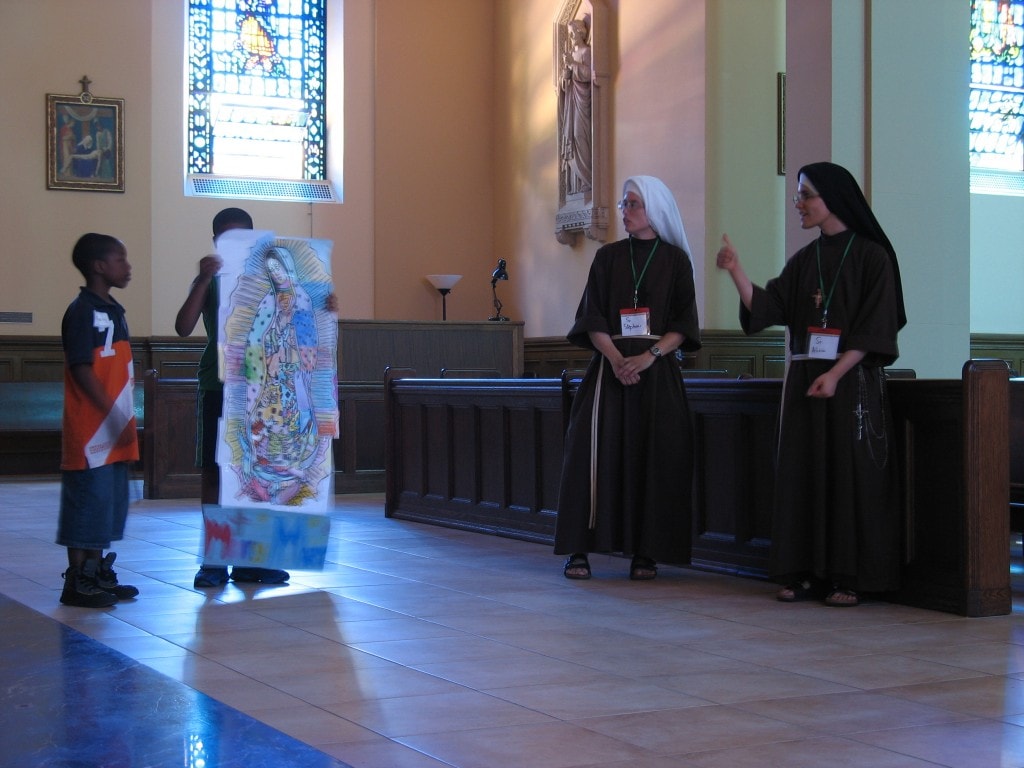 One of your youth holds up the picture of Our Lady of Guadalupe that the kids made together.